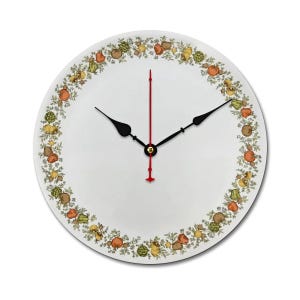May include: White round clock with black hands and a red second hand. The clock face has a border of green leaves and colorful fruits.
