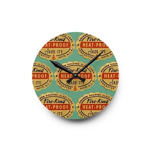 May include: A round clock with a green background and a repeating pattern of gold and red labels that say "Fire-King Heat-Proof Jade-ite Anchor Hocking Glass Corp. Lancaster Ohio U.S.A."