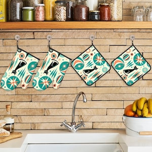 May include: Set of four kitchen pot holders with a retro mid-century modern design featuring a black cat and teal, white, and orange geometric shapes.