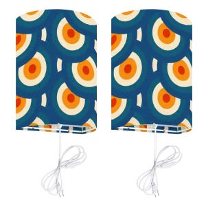 May include: Two matching lampshades with a retro design. The shades feature a pattern of overlapping circles in shades of blue, orange, and cream. Each shade has a white cord and plug for easy use. The lampshades are designed to provide soft, ambient lighting.