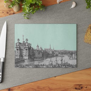 May include: A vintage illustration of a city skyline with a harbor and ships. The illustration is printed on a light blue background.