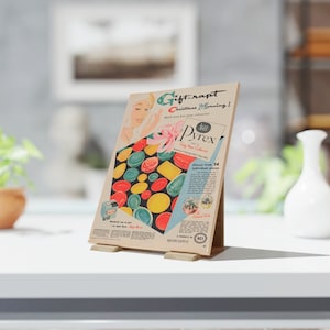 May include: An advertisement for Pyrex dishes, featuring a retro design with colorful plates and the text "Gift-rapt Christmas Morning!" The ad showcases a variety of dish shapes and colors, with a woman's illustration and the Pyrex logo.