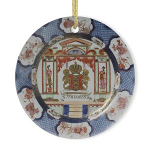May include: A round porcelain ornament with a blue and white patterned border. The center features a colorful depiction of a coat of arms with two lions and the text "AMSTERDAM".