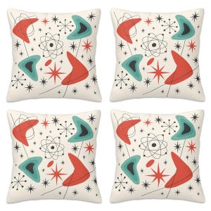 May include: Four square throw pillows with a mid-century modern design. Each pillow features a cream background with a pattern of red boomerangs, teal shapes, starbursts, and atomic-style graphics in black.
