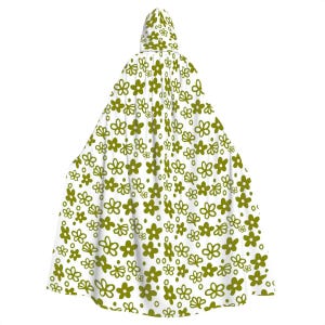 May include: White hooded cape with a green floral pattern. The cape has a pointed hood and is made of a soft, lightweight fabric.