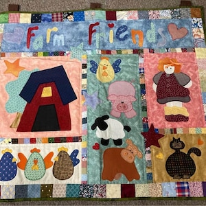 May include: A colourful patchwork quilt with the words "Farm Friends" in the centre. The quilt features various farm animals, including a pig, a cow, a chicken, and a cat. There is also a red barn and a girl wearing a red dress.