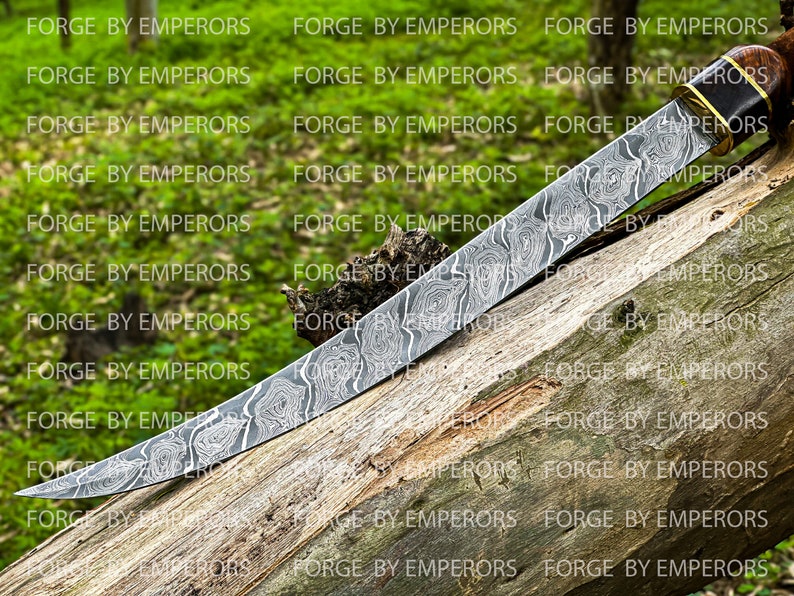 May include: A curved, silver-colored knife with a patterned blade and a wooden handle. The knife is resting on a piece of wood with a green background.