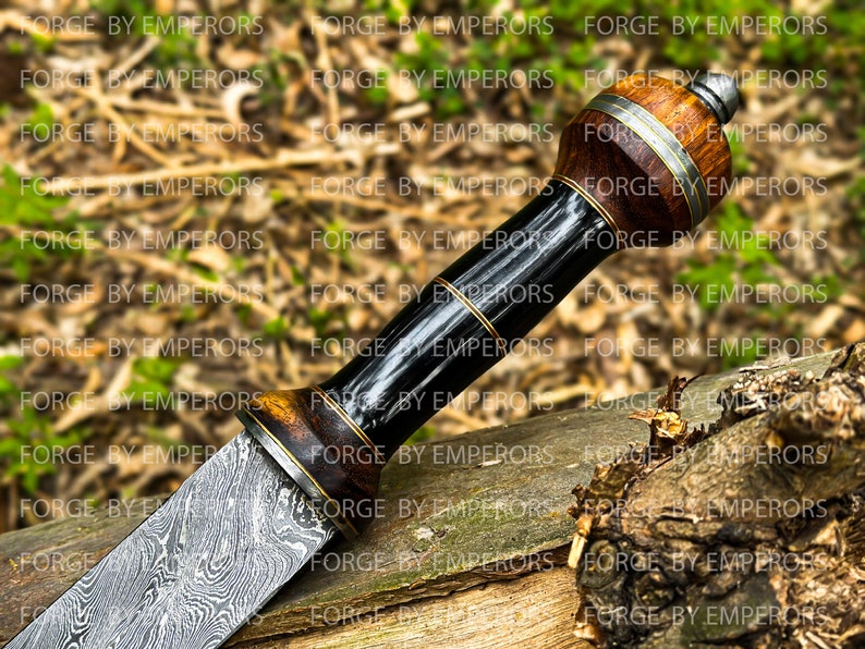 May include: A close-up of a Damascus steel knife with a wooden handle. The handle is wrapped in black leather and has a brass accent. The blade is highly polished and has a distinctive pattern.