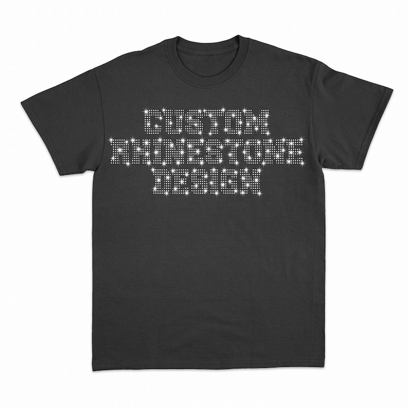 May include: A black t-shirt with the words "CUSTOM RHINESTONE DESIGN" spelled out in white rhinestones.