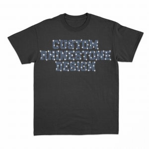 May include: A black t-shirt with the words "CUSTOM RHINESTONE DESIGN" spelled out in rhinestones.