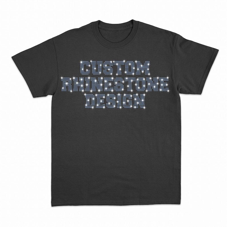 May include: A black t-shirt with the words "CUSTOM RHINESTONE DESIGN" spelled out in rhinestones.