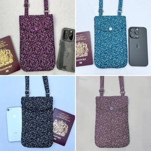 May include: Four different phone pouches with a floral pattern. Each pouch has a strap and a button closure. The pouches are in purple, teal, black, and burgundy.