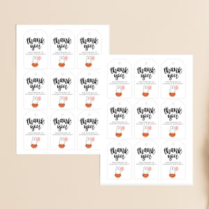 May include: A set of 12 white thank you tags featuring a black and white illustration of a bunny wearing an orange dress and holding a pink balloon. The text on the tags reads "Thank you for coming to [name]'s birthday!"