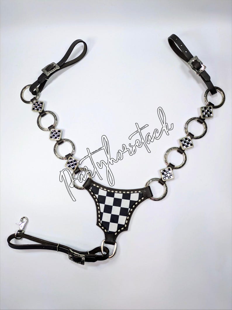 May include: Black and white checkered horse tack with silver-toned accents. The tack features a series of silver rings and square embellishments, connected by black leather straps. The text "partyhorsetack" is written in cursive.