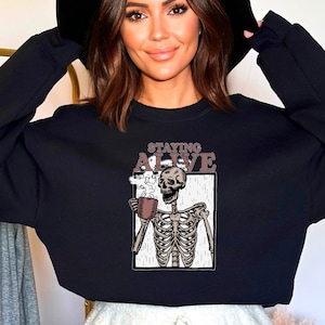Staying Alive Skeleton Holding Mug Hoodie, Tea Lover Skeleton Sweater, Coffee Lover Skeleton Vintage Style Hoodie and Sweatshirt for Friends