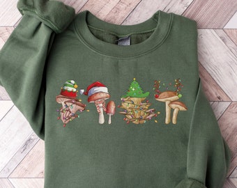 May include: A green sweatshirt featuring a Christmas-themed mushroom design. The mushrooms are wearing Santa hats and have Christmas lights around them.