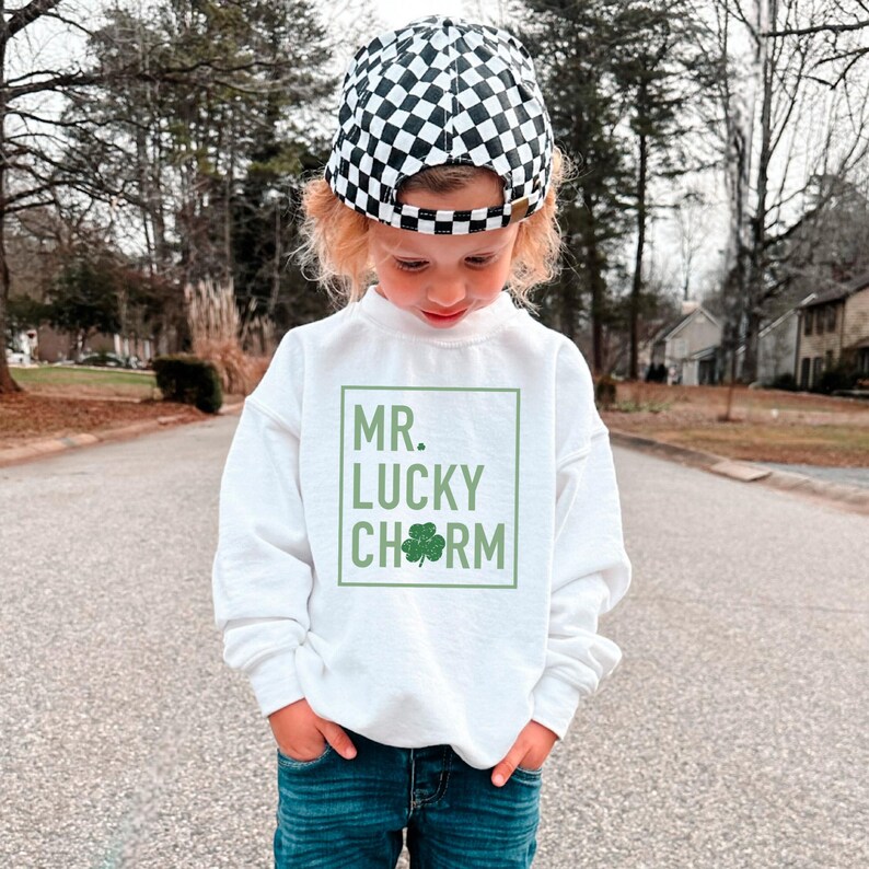 May include: A white sweatshirt with a green shamrock and the text "MR. LUCKY CHARM" in a green box.