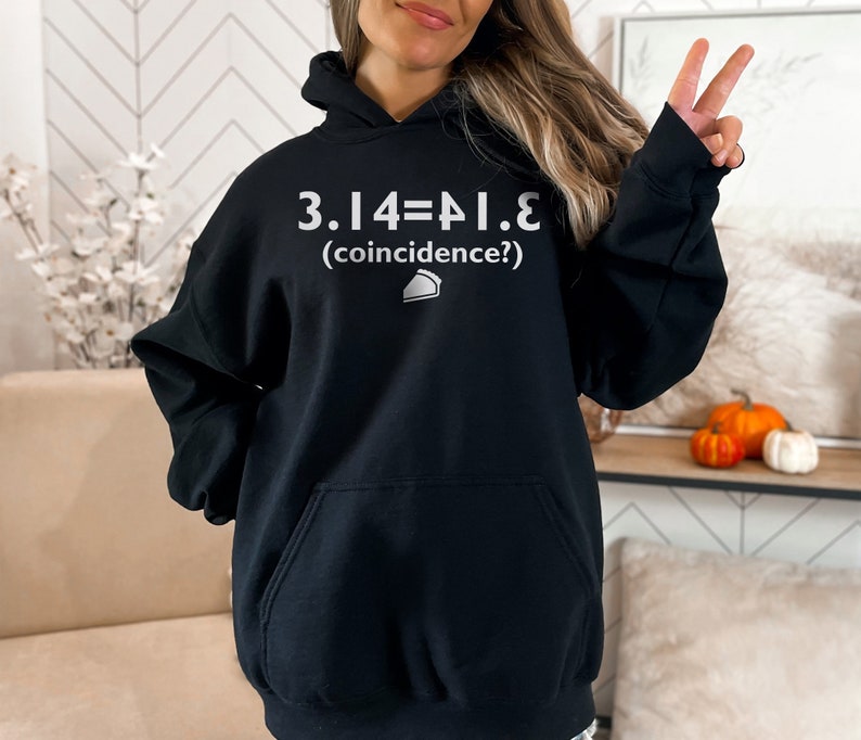 May include: Black hoodie with a white graphic that reads "3.14=&pi;.e (coincidence?)" and a small pie slice icon.