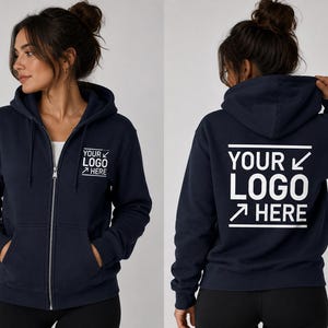 May include: A navy blue zip-up hoodie featuring a hood with drawstrings, long sleeves, and two front pockets. The front left chest displays the white text "YOUR LOGO HERE" with arrows, and the back features a larger version of the same white text.