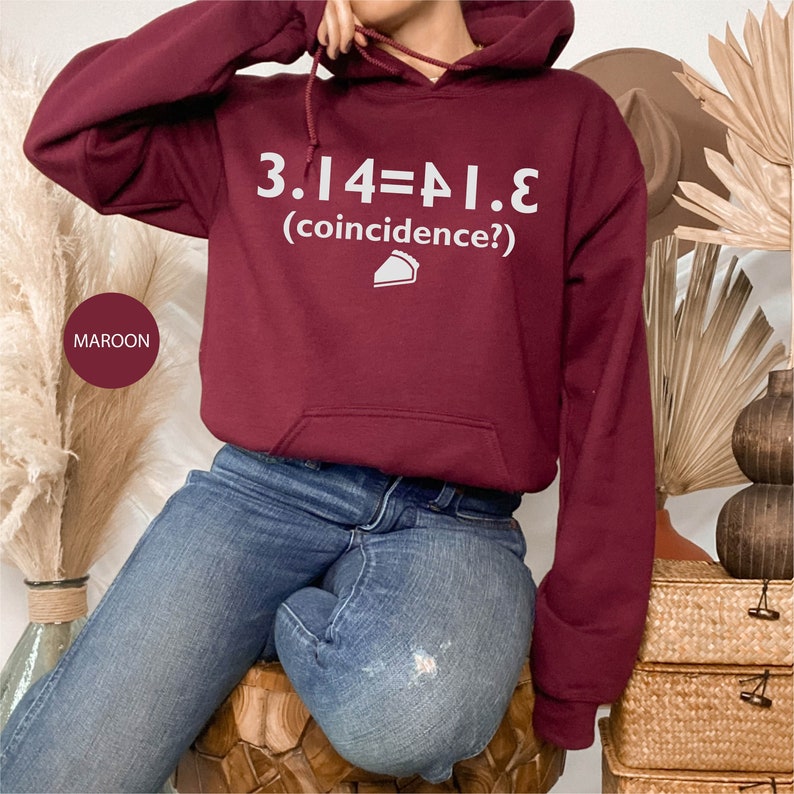 May include: A maroon hoodie with a white graphic that reads "3.14=PI.E (coincidence?)" and a small pie slice icon.