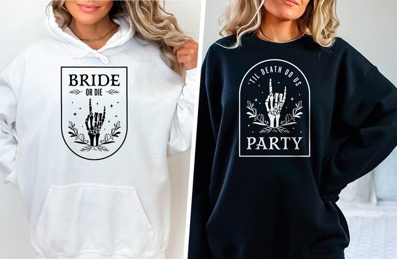 May include: Two hoodies with a gothic wedding theme. The white hoodie says "Bride or Die" with a skeleton hand making a rock and roll sign. The black hoodie says "Til Death Do Us Party" with a skeleton hand making a rock and roll sign.