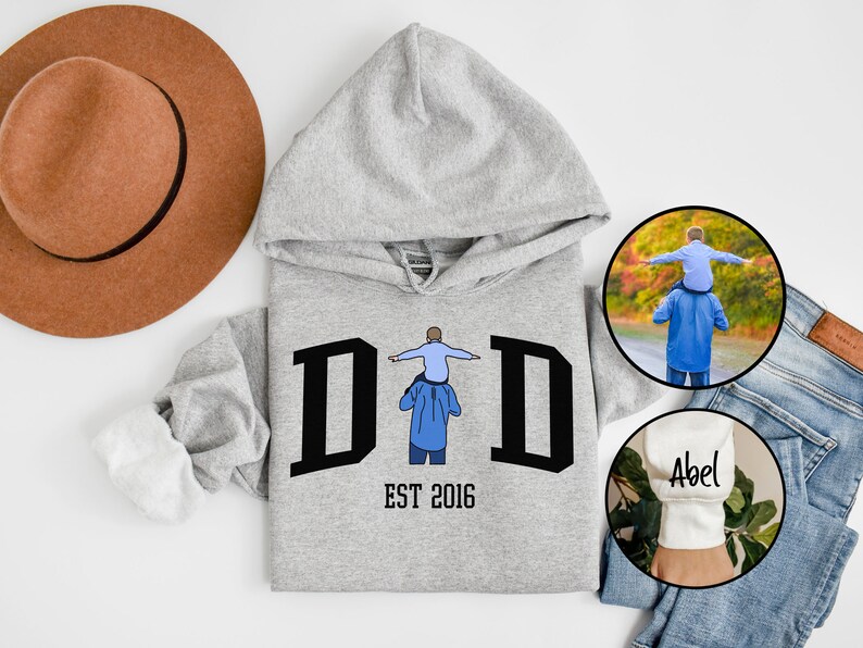 May include: Gray hooded sweatshirt with the word "DID" in black letters and the text "EST 2016" below. A small illustration of a father carrying a child on his shoulders is in the center of the word "DID".
