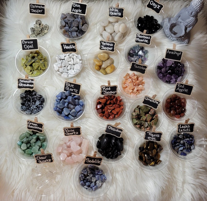 May include: Assortment of tumbled stones in small bowls, including Dalmatian Jasper, Blue Agate, White Quartz, Onyx, Green Opal, Howlite, Yellow Jasper, Rainbow Fluorite, Amethyst, Smokey Obsidian, Blue Quartz, Red Jasper, Sunstone, Unakite, Red Agate, Green Aventurine, Rose Quartz, Obsidian, Tigers Eye, Lapis Lazuli, Clear Quartz, and Sodalite.