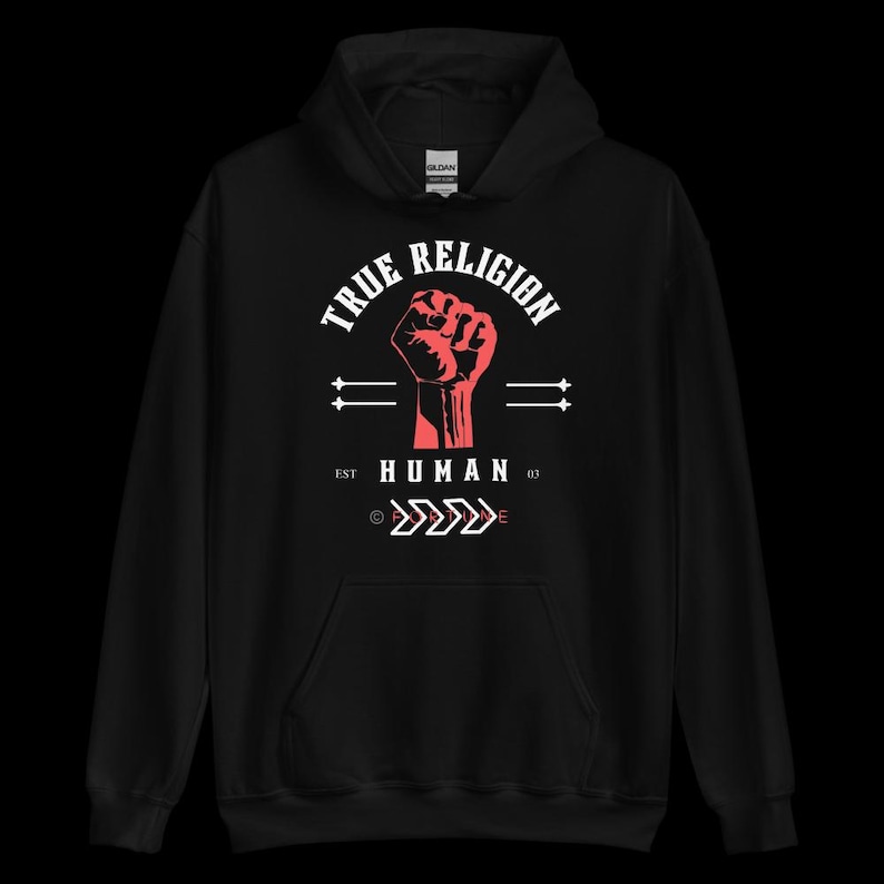 May include: Black hooded sweatshirt with a red fist graphic and the text "TRUE RELIGION" above and "HUMAN 03" below. The design includes arrows and horizontal lines. Made of a soft material.