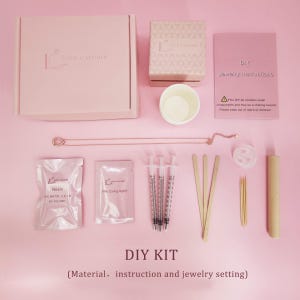 a DIY kit for jewelry making, including various materials, instructions, and a jewelry setting.