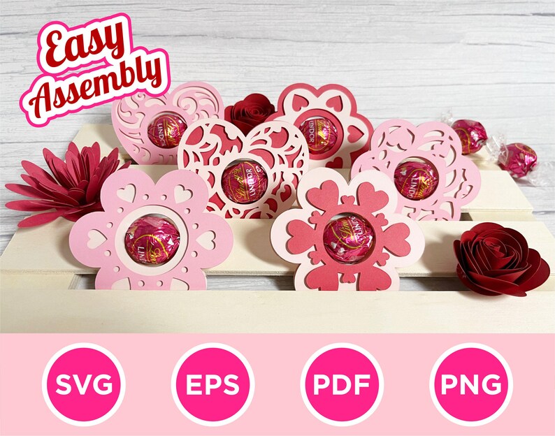 May include: Pink and red paper flower-shaped and heart-shaped holders with Lindor chocolate candies inside. The words "Easy Assembly" are in the top left corner. The bottom of the image has SVG, EPS, PDF, and PNG icons.