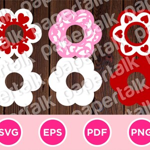 May include: A collection of flower-shaped cutouts in white, pink, and red, with heart and floral patterns. The image includes SVG, EPS, PDF, and PNG file type icons, suggesting digital design resources. The cutouts are arranged on a wooden background.