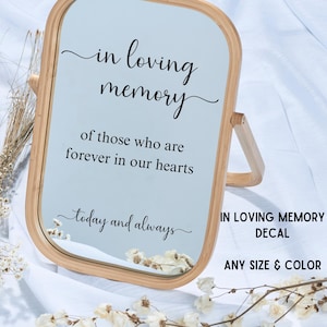 May include: A wooden-framed mirror with the text "in loving memory" and "of those who are forever in our hearts" in black script. The words "today and always" are also written on the mirror. The text "IN LOVING MEMORY DECAL" and "ANY SIZE & COLOR" are also visible.