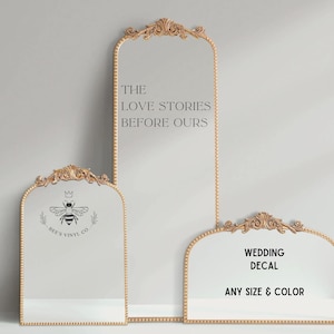 May include: Three gold-framed mirrors with decorative tops. The largest mirror has the text "THE LOVE STORIES BEFORE OURS." The middle mirror features a bee logo and the text "BEE'S VINYL CO." The smallest mirror says "WEDDING DECAL ANY SIZE & COLOR."