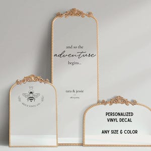 May include: Three ornate gold mirrors with decorative details. The largest mirror has the text "and so the adventure begins..." and "tara & jessie 08.15.2025". The middle mirror has a bee with a crown and the text "BEE'S VINYL CO.". The smallest mirror has the text "PERSONALIZED VINYL DECAL ANY SIZE & COLOR".