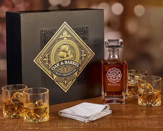 A fully engraved firefighter-themed decanter set in a keepsake wooden box — a genuinely thoughtful, personalized tribute gift for first responders that feels ceremonial rather than generic.