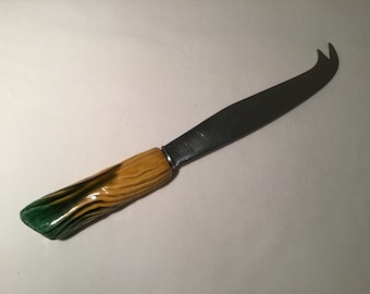 French vintage cheese knife with ceramic handle that looks like a log.