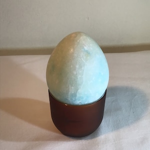 French vintage blue and white marble / stone egg on an egg cup stand.