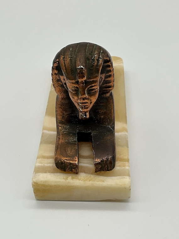 エジプトのヴィンテージ ギザのスフィンクスの堅牢な彫像。金色の金属