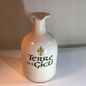 Italian vintage terracotta olive oil bottle. It is made from terracotta and has a cream glazed finish.