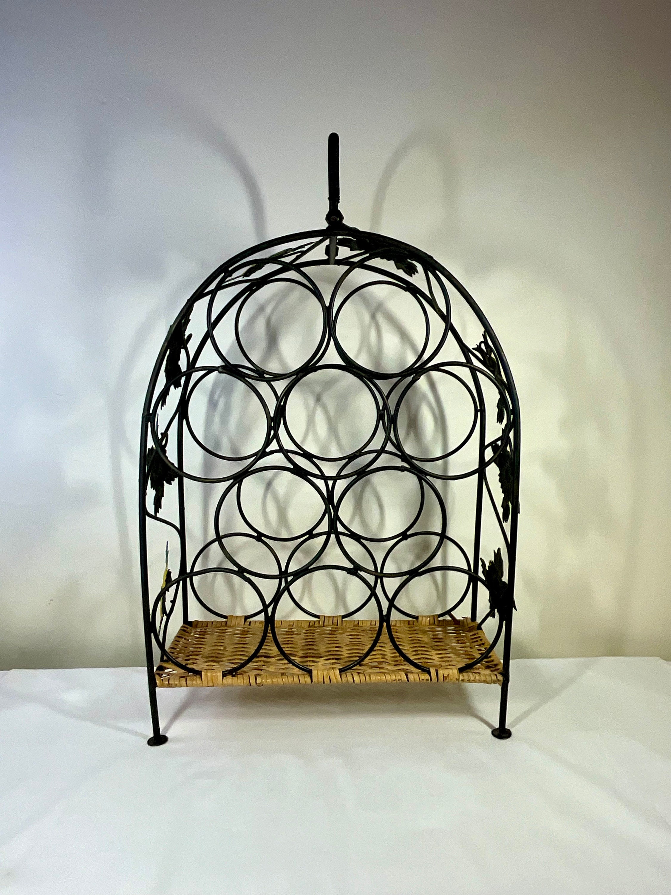 Beautiful French vintage hand made ornate free standing metal & basket weave wine bottle rack with compartments for holding 10 bottles.