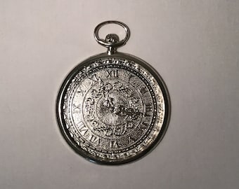 French vintage silver metal coaster with an embossed clock face pattern.