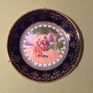 Limoges France vintage elegant porcelain small plate / bowl / ornament with a picture and a gold and blue edge.