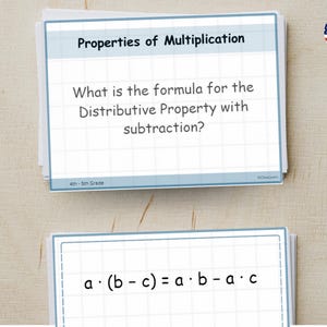 May include: A stack of flashcards with the title "Properties of Multiplication." The top card asks, "What is the formula for the Distributive Property with subtraction?" The bottom card shows the formula a · (b - c) = a · b - a · c.