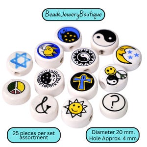 May include: A collection of white ceramic beads with various symbols, including a Star of David, yin-yang, peace sign, and sun. The beads are approximately 20 mm in diameter with a 4 mm hole. The set includes 25 pieces and is from BeadsJeweryBoutique.