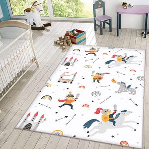 May include: White rug with a repeating pattern of knights, castles, rainbows, stars, and arrows. The knights are wearing red and yellow armor and riding horses or dragons.