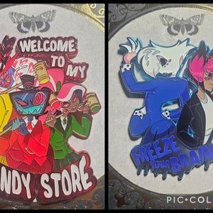 May include: Two enamel pins featuring cartoon characters. One pin reads "WELCOME TO MY CANDY STORE" with characters in red, yellow, green, and blue. The other pin says "FREEZE YOUR BRAIN" with characters in blue and pink.