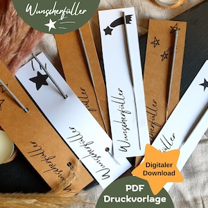 Peut inclure: Un ensemble de six étiquettes en papier brun et blanc avec des motifs d'étoiles noires et d'étoiles filantes. Chaque étiquette est munie d'une étincelle argentée et du texte "Wunschzerfüller" imprimé dessus. Les étiquettes sont disposées sur une surface en tissu brun. Le texte "Digitaler Download" et "PDF Druckvorlage" est imprimé sur une étoile jaune.