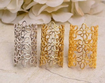 May include: Three decorative rings with a floral design. The rings are made of metal and are available in silver, gold, and rose gold.