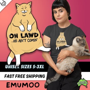May include: Black t-shirt with a cartoon cat illustration and the text "Oh Lawd...He Ain't Comin'" printed on the front. The cat is sitting with its paws crossed and has a smug expression on its face.