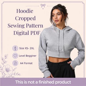 May include: A digital PDF sewing pattern for a cropped hoodie, featuring text that reads Hoodie Cropped Sewing Pattern Digital PDF, Size XS- 2XL, Level Begginer, A4 Format, and This is not a finished product. The image shows a grey cropped hoodie.